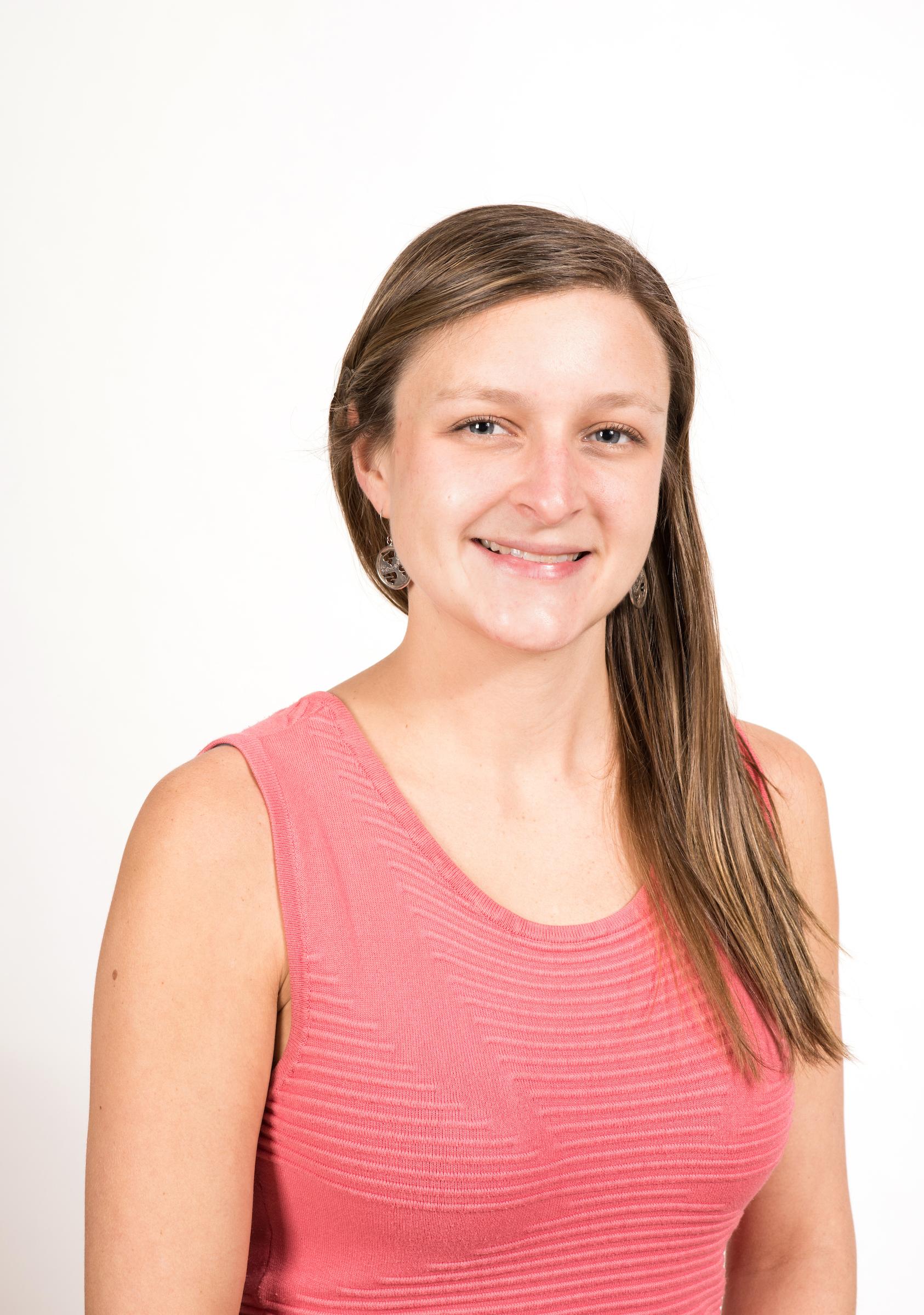 Headshot of woman wearing a pink sleeveless short